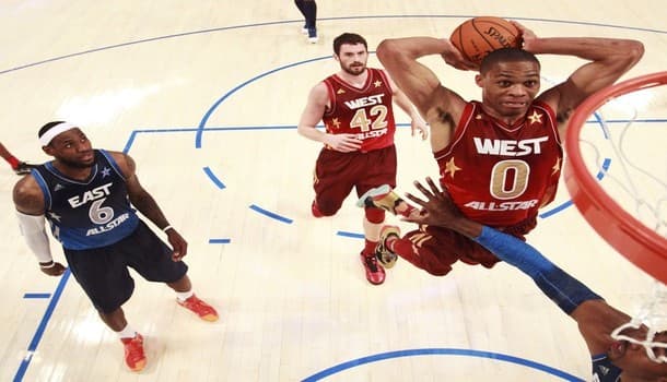 West All-Stars Russell Westbrook of the Oklahoma Thunder dunks as East All Stars LeBron James and West's Kevin Love looks on