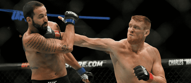 Sam Alvey lands a heavy punch on the chin of Alex Nicholson