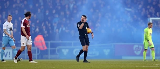 Coventry supporters threw flares onto the pitch to disrupt the game at Northampton.