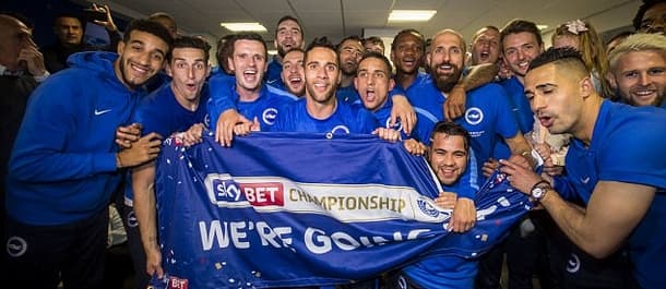 Brighton celebrated promotion with a 2-1 win over Wigan.