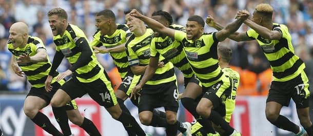 Huddersfield players celebrate promotion to the Premier League.