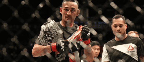 Max Holloway celebrates winning the UFC featherweight championship