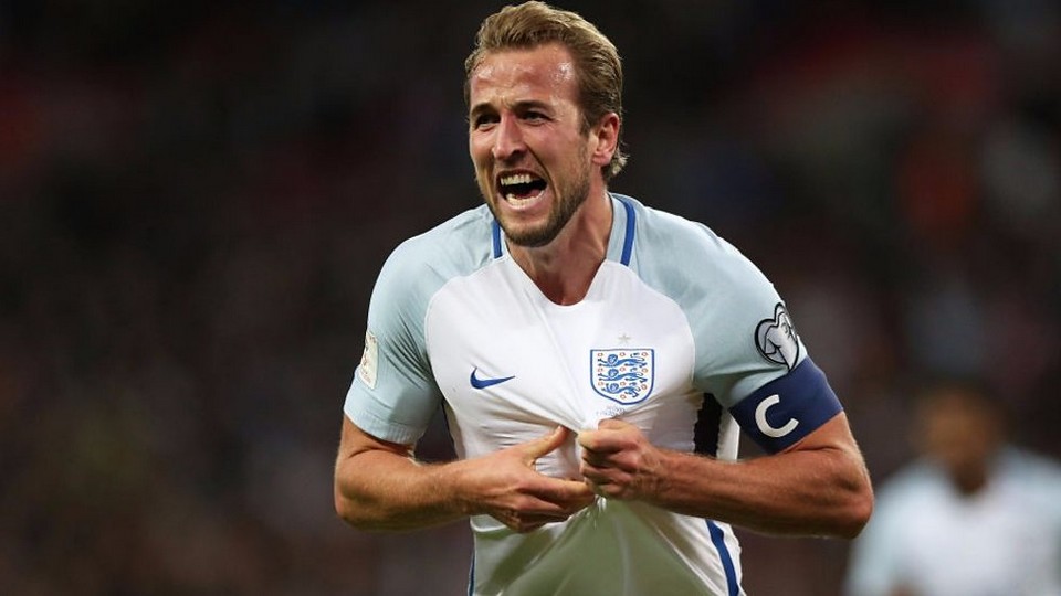 Harry Kane grabbing his England shirt