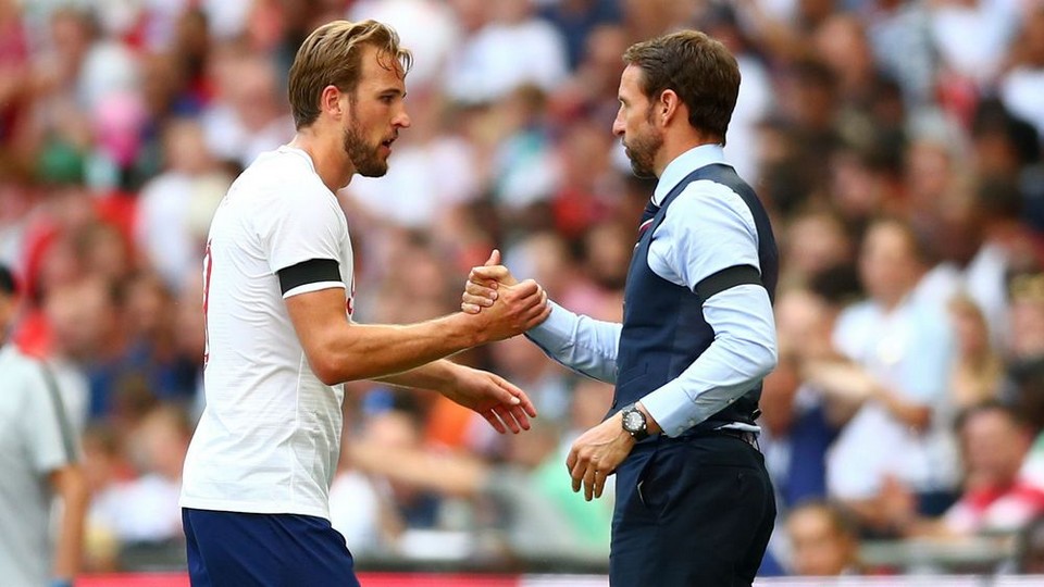 Gareth Southgate and Harry Kane embracing after England win