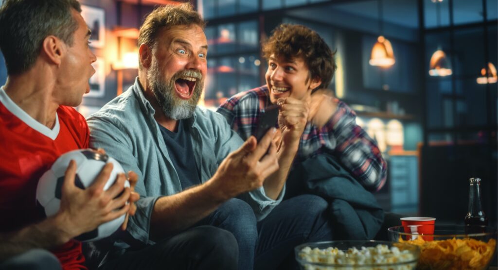 Three males celebrating winning bet