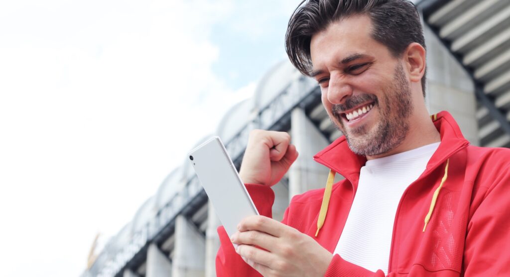 Man celebrating winning mobile bet