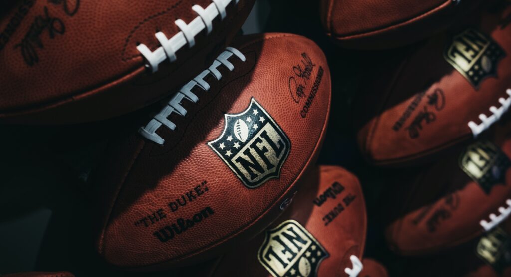 Rows of NFL footballs