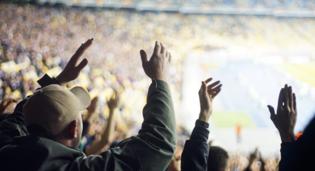 Football fans clapping in stands