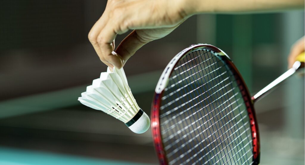 Badminton player preparing to serve