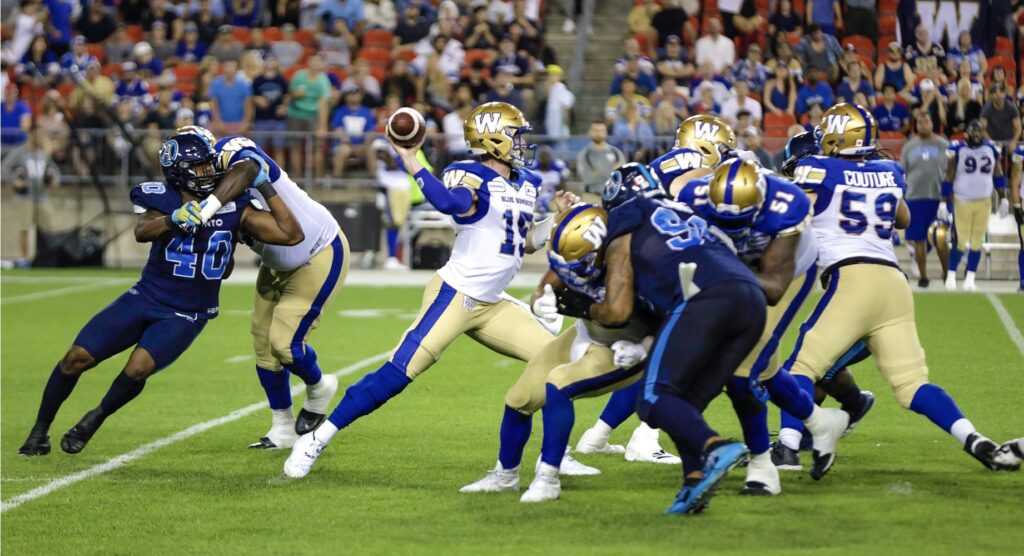 Quarterback throwing the ball during CFL game