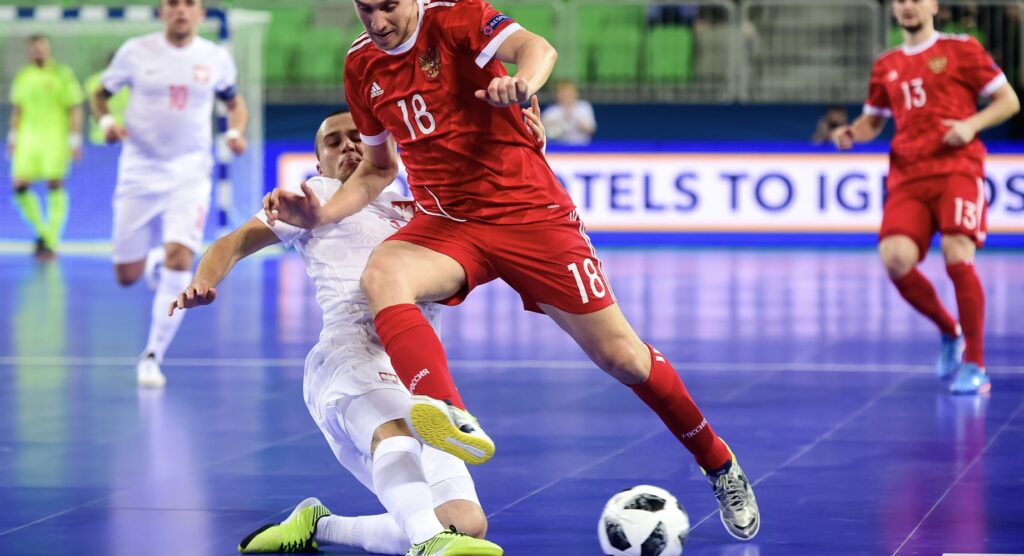 Futsal player tackling opponent during match