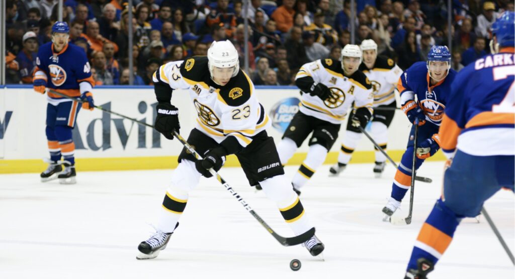 Ice hockey player trying to control puck during match