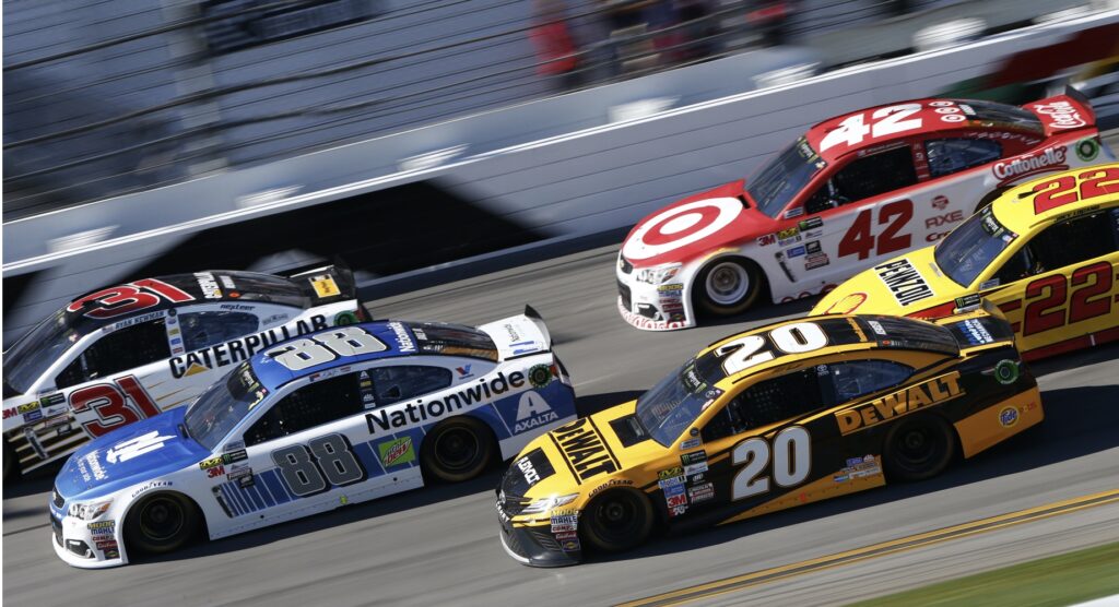 Four cars accelerating during NASCAR race 