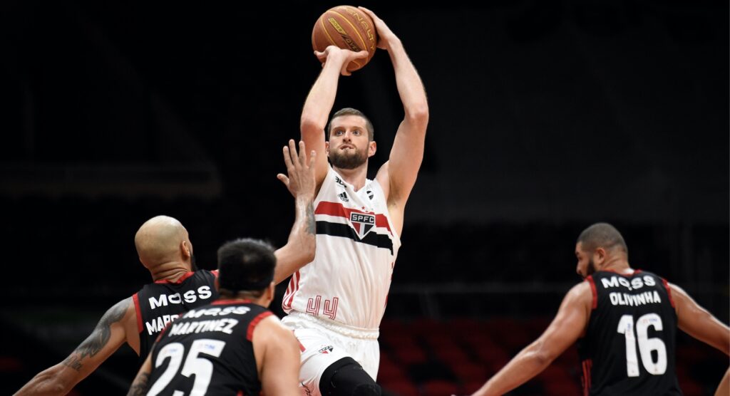 Basketball player taking a shot while jumping