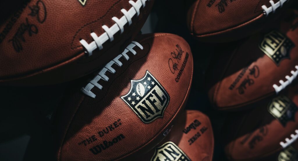 Rows of NFL footballs