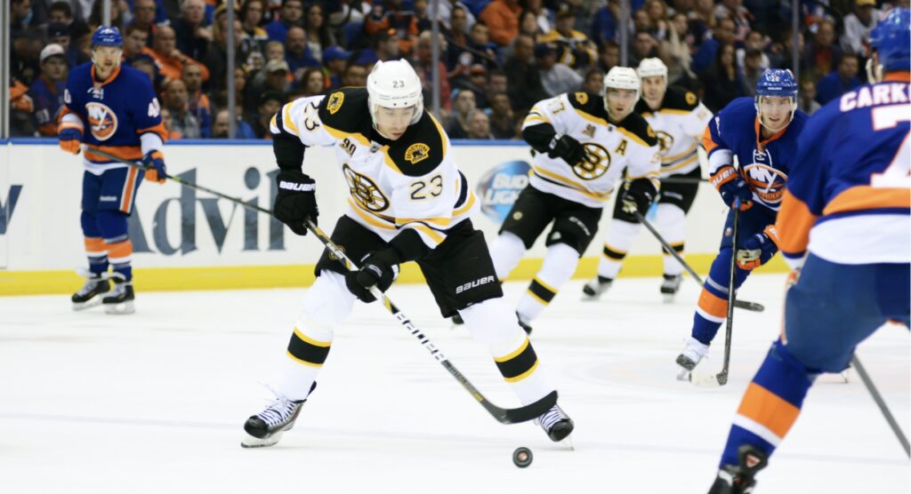 Ice hockey player trying to control puck during match