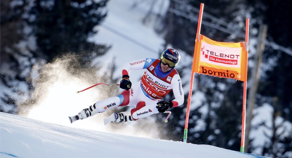 Male skier snaking around flag