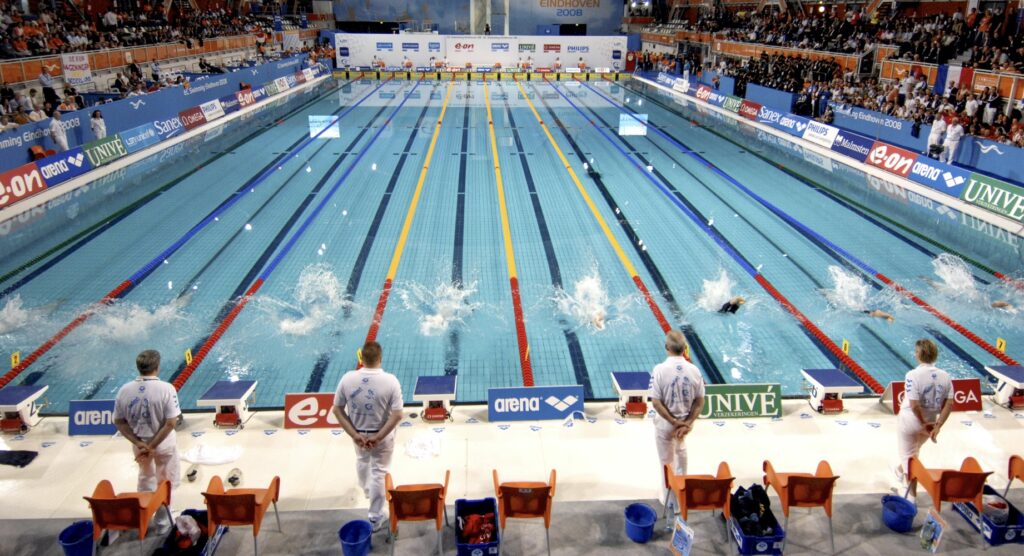 Officials waiting for the start of a swimming race