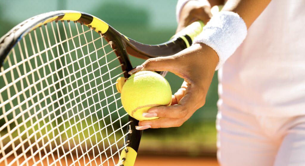 Close-up of female tennis player preparing to serve