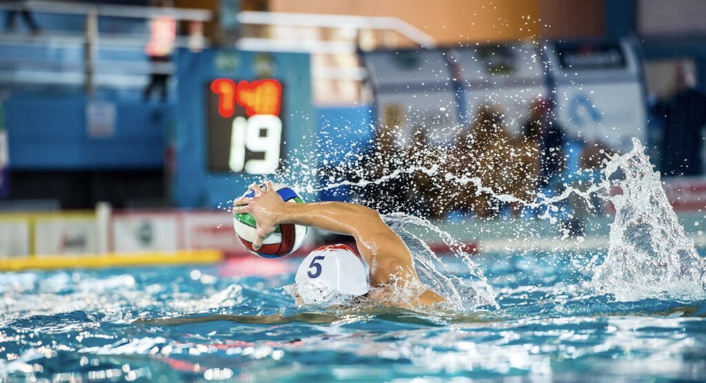 Water polo player controlling ball