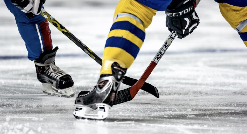 Ice hockey players competing for control of puck during face-off