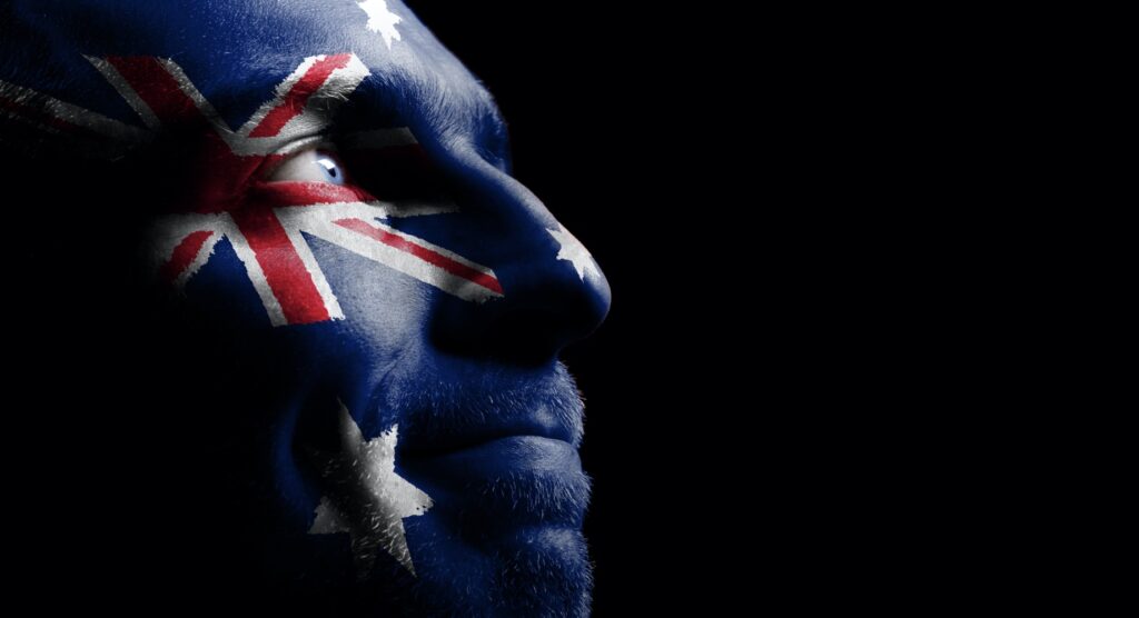 Man with the flag of Australia painted on his face