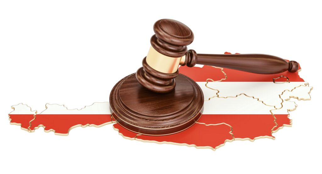 Wooden gavel on map of Austria