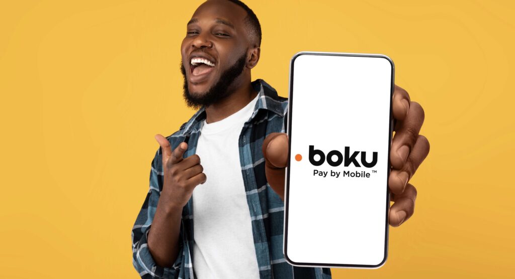 Man holding smartphone displaying Boku logo
