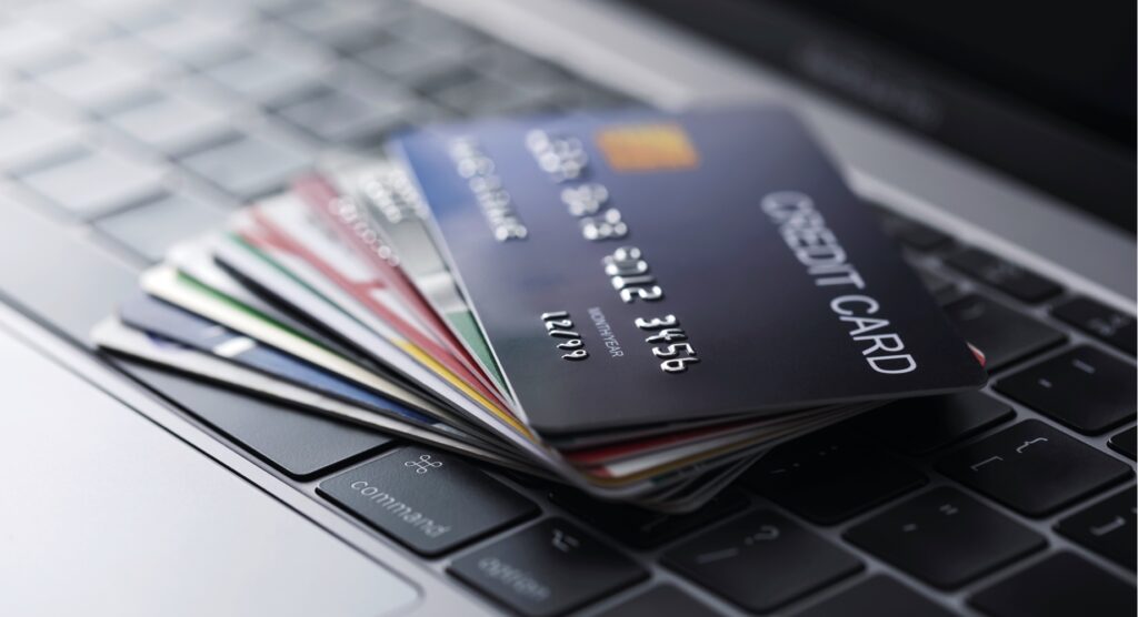 Stack of credit cards on laptop keys