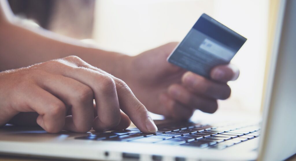 Person entering credit card details on laptop