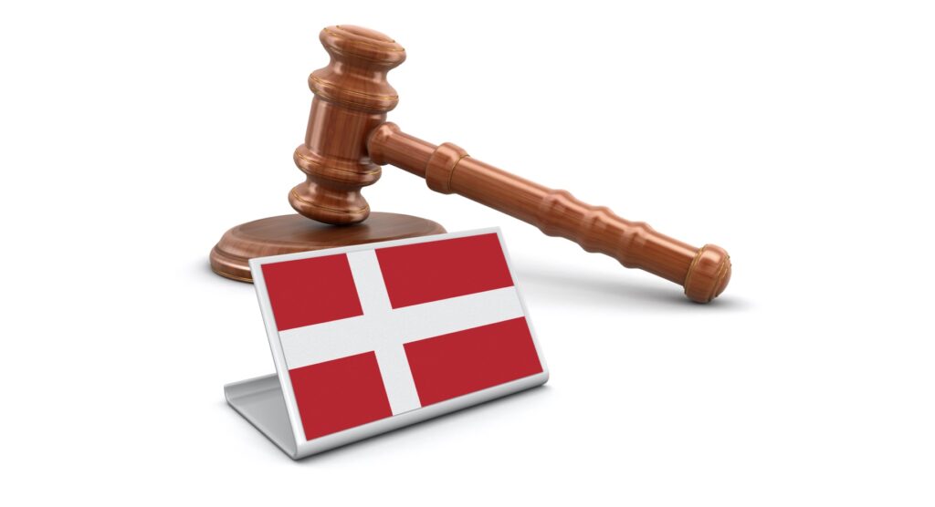 Wooden gavel and flag of Denmark