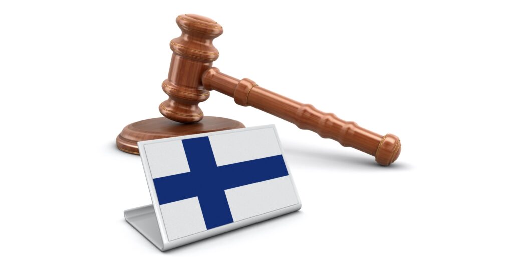 Wooden gavel and flag of Finland