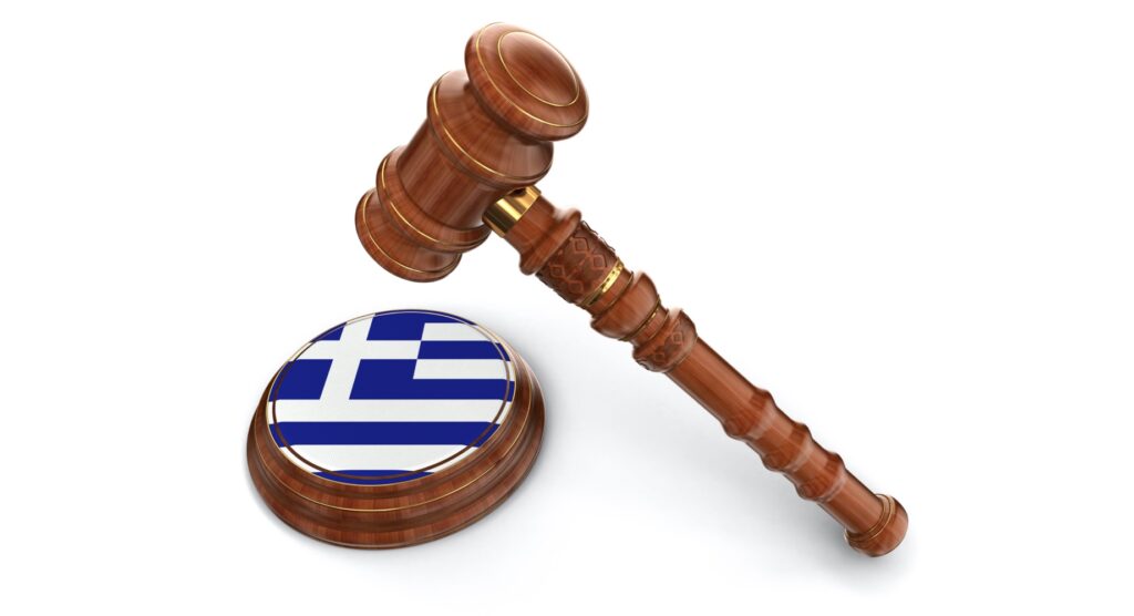 Wooden gavel and flag of Greece