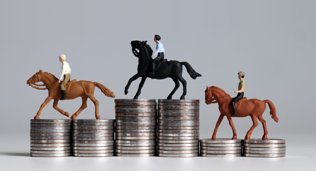 Miniature horses on stacks on coins