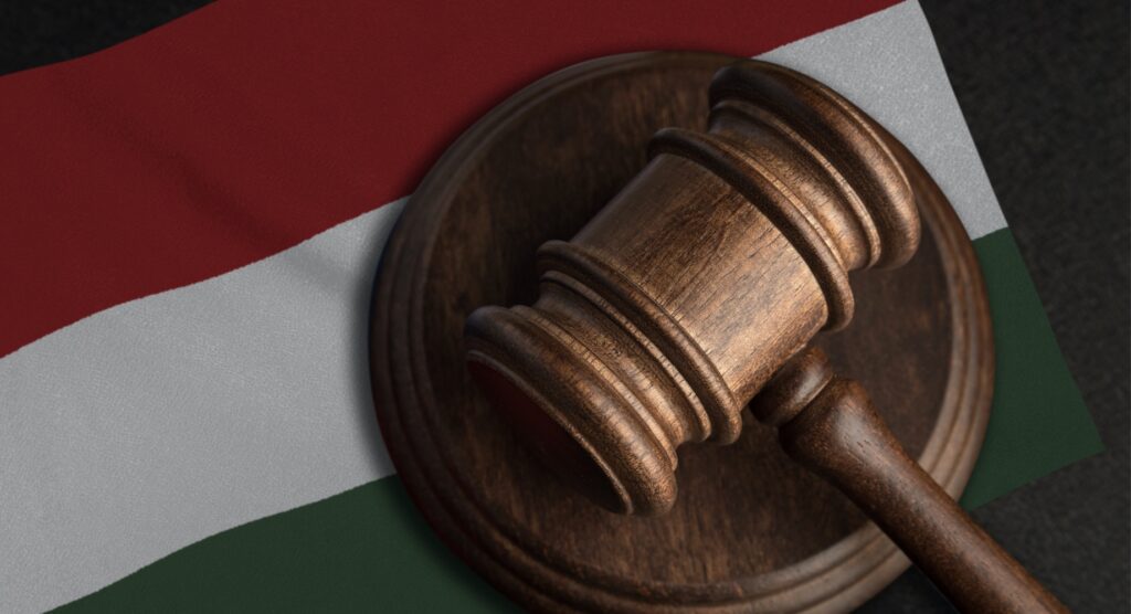 Wooden gavel on flag of Hungary