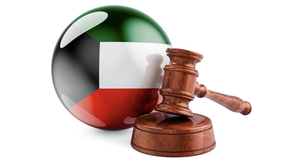 Wooden gavel and flag of Kuwait
