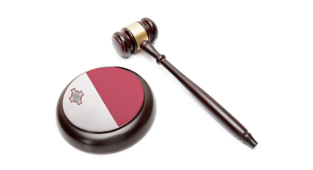 Wooden gavel and flag of Malta