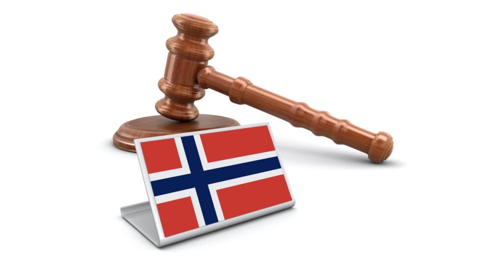 Wooden gavel and flag of Norway