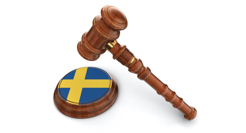 Wooden gavel and flag of Sweden