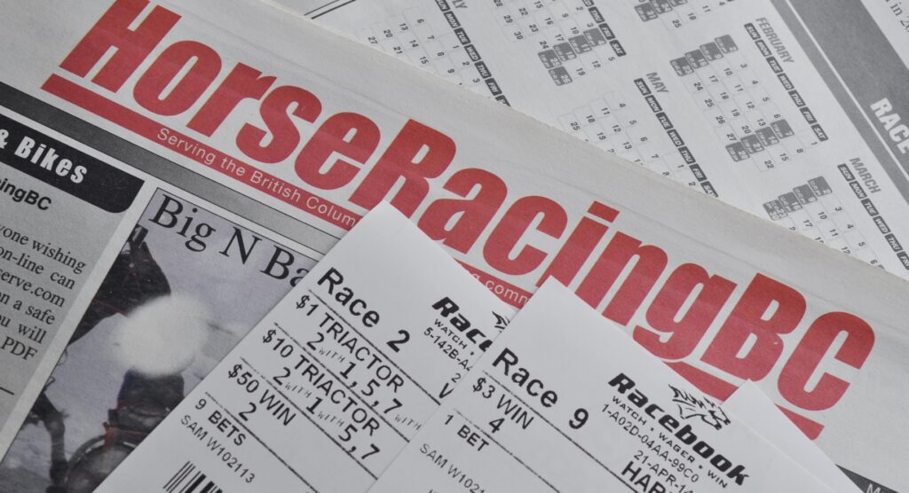 Betting slips on horse racing newspaper