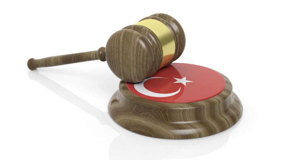 Wooden gavel and flag of Turkey