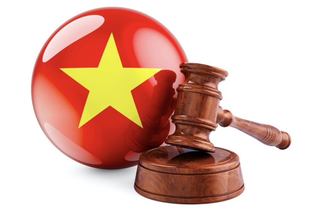 Wooden gavel and flag of Vietnam