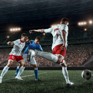 Three footballers competing for the ball