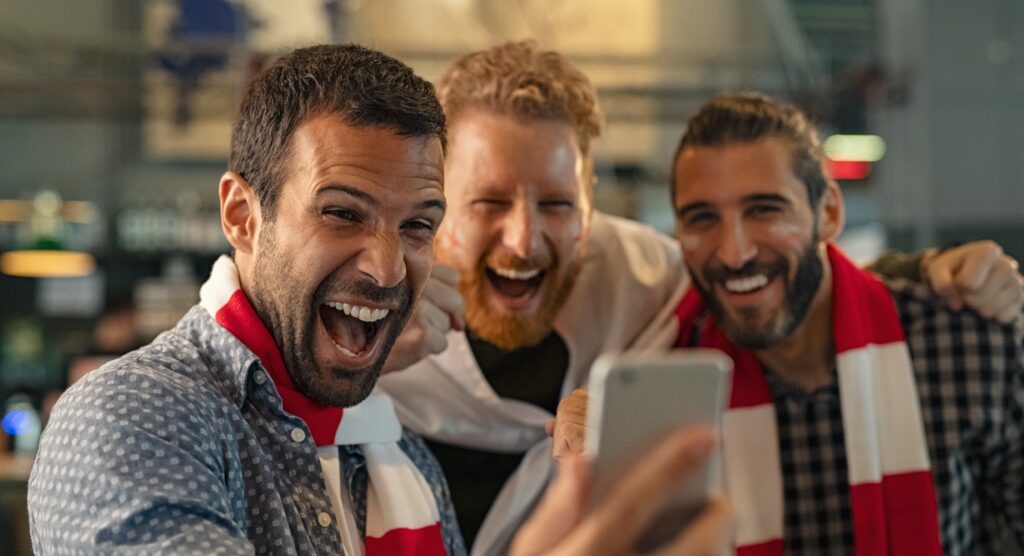 Three male friends celebrating winning bet