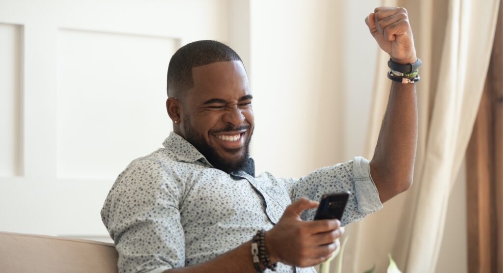 Male celebrating winning bet Male celebrating winning bet