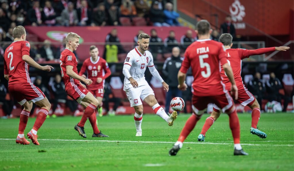 Attacking football player passing the ball