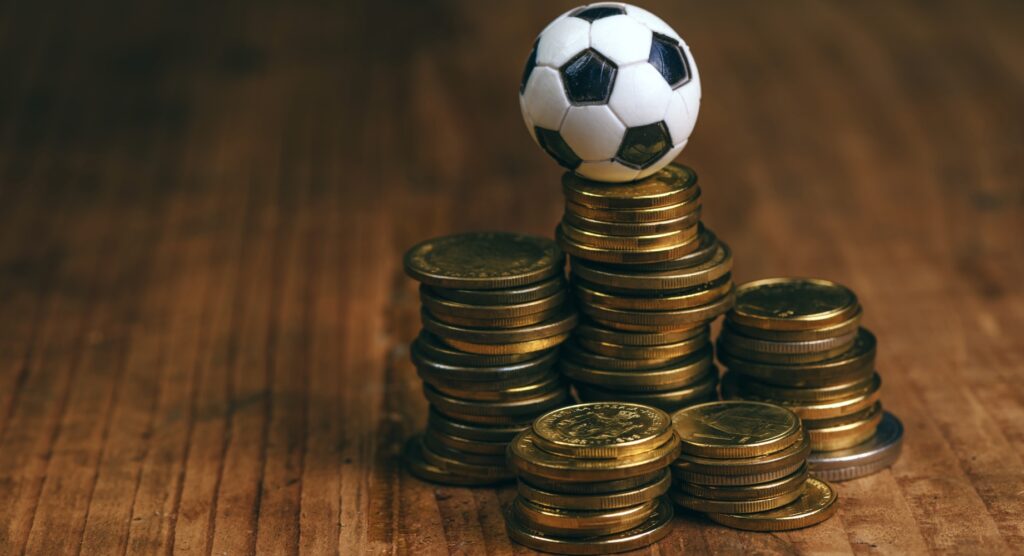 Football toy on stack of coins