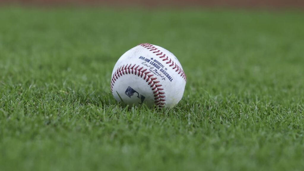 Batter swinging at ball during baseball game Official MLB ball