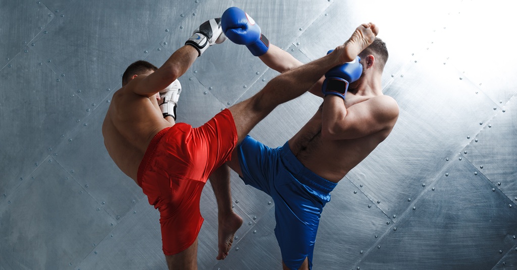 Two men boxers fighting muay thai kickboxing