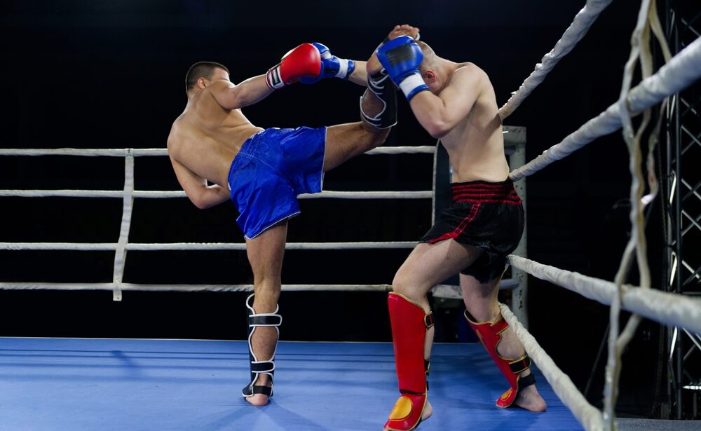 Kickboxing rivals unleash powerful leg strikes in a thrilling match